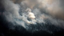 This aerial picture taken from an airplane on July 27, 2021, shows the smoke rising from a forest fire outside the village of Berdigestyakh, in the republic of Sakha, Siberia. - Russia is plagued by widespread forest fires, with the Sakha-Yakutia region in Siberia being the worst affected. According to many scientists, Russia -- especially its Siberian and Arctic regions -- is among the countries most exposed to climate change. The country has set numerous records in recent years and in June 2020 registered 38 degrees Celsius (100.4 degrees Fahrenheit) in the town of Verkhoyansk -- the highest temperature recorded above the Arctic circle since measurements began. (Photo by Dimitar DILKOFF / AFP) (Photo by DIMITAR DILKOFF/AFP via Getty Images)