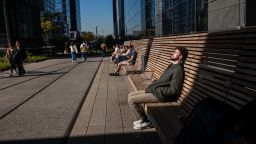 NEW YORK, NEW YORK - OCTOBER 21: People rest in the sun along the High Line on October 21, 2024 in New York City. New York City and much of the Northeast are experiencing unusually high temperatures this autumn, with temperatures expected to reach near 80 in Manhattan this afternoon. (Photo by Spencer Platt/Getty Images)