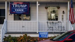 A Trump/Vance campaign flag hangs in front of one side of a duplex home while a Harris/Walz campaign sign is seen in front of the other side in Pen Argyl, Pennsylvania on November 2, 2024. (Photo by SAMUEL CORUM / AFP) (Photo by SAMUEL CORUM/AFP via Getty Images)